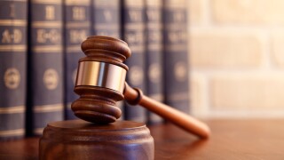 Gavel leaning against a row of law books