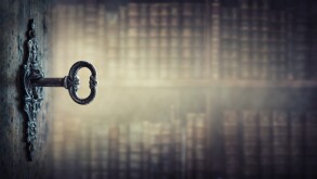 Old key in keyhole, macro shot. Gothic style. Key to knowledge. 