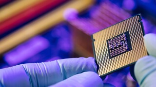 Computer support engineer installing processor. Microprocessor with clearly visible silicon core and cache chip. Installation of computer processor in the socket