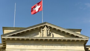 Swiss flag and statue of Justice on Federal Supreme Court of Switzerland. Lausanne, Switzerland