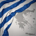 waving colorful national flag and map of greece.