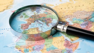 Magnifying glass close up with world map