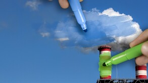 Hands painting blue and green pollution from a chimney