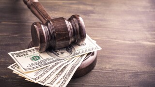 Gavel and dollars banknotes on table