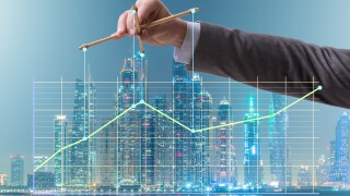 Businessman controlling the market with strings