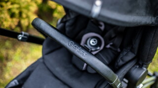 Budapest, Hungary - April 18, 2021: Cybex Priam Black stroller or pram in the park. Infant carriage seat. Close up image with soft focus.