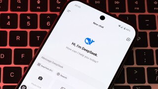 DeepSeek AI interface is seen on the smartphone placed on laptop keyboard. Concept for a new chat bot, competitor to Chat GPT. Stafford, United Kingdom, January 26, 2025