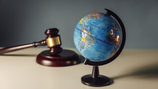Concept of world justice. Wooden gavel and globe on a table