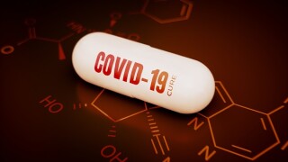 Concept of a covid-19 coronavirus cure. 3d rendering of a pill on a hi tech red background with chemical formula.