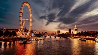 Ferris Wheel In City At Sunset