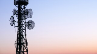 Telecommunication tower Antenna at sunset sky.
