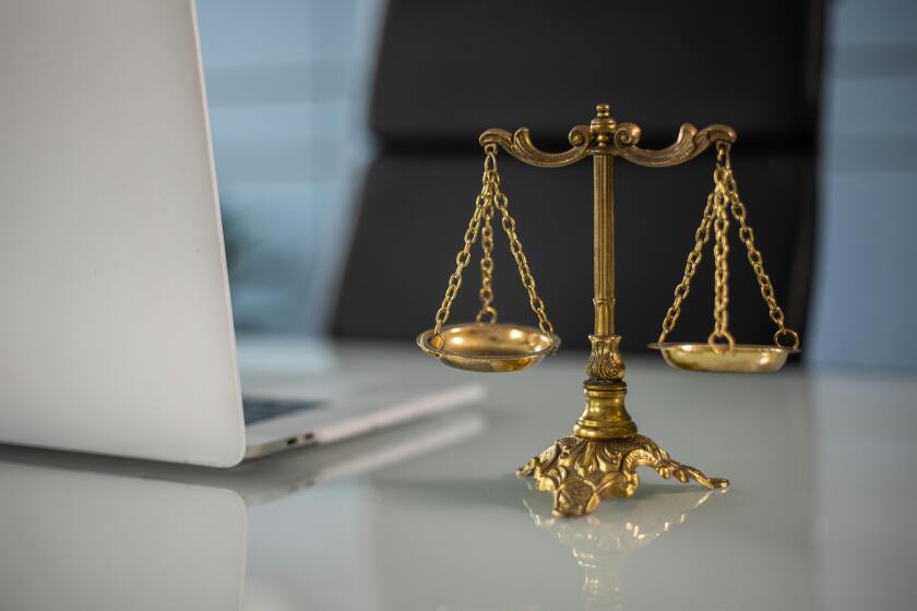 Scales of justice by a laptop