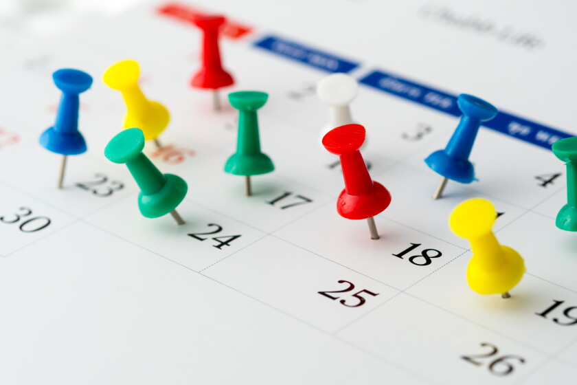 Push pins on calendar. Idea concept of to do planning.