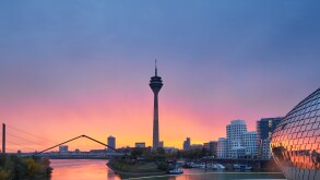 Rainy sunrise in the city of Dusseldorf in Germany. The urban landscape of the city of Düsseldorf. View of the Rheinkniebrücke bridge and the Media Harbor during the golden hour