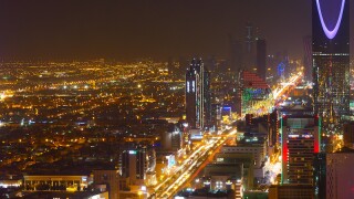 Panorama view to the skyline of Riyadh by night, with the Kingdom centre in the background and blue lighting, the capital of Saudi Arabia