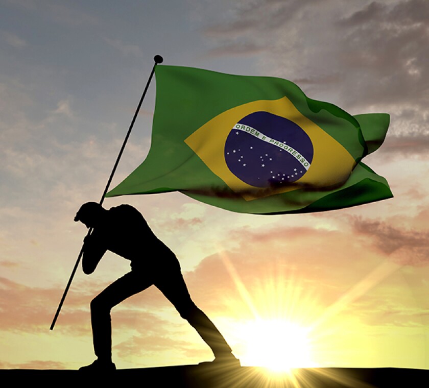 Brazil flag being pushed into the ground by a male silhouette. 3